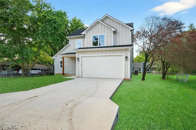 a front view of house with yard and green space