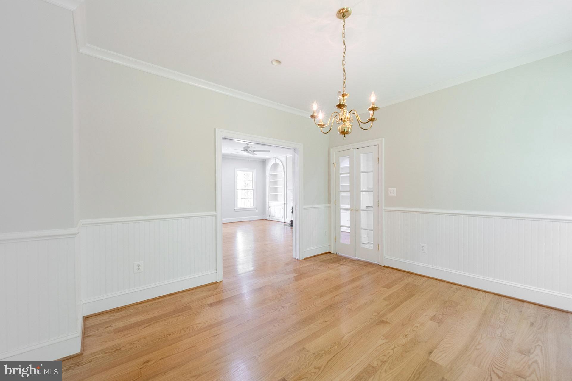 11208 West Montpelier Road Great Falls, VA 22066 - Photo 21 of 77 a view of an empty room with wooden floor and a window
