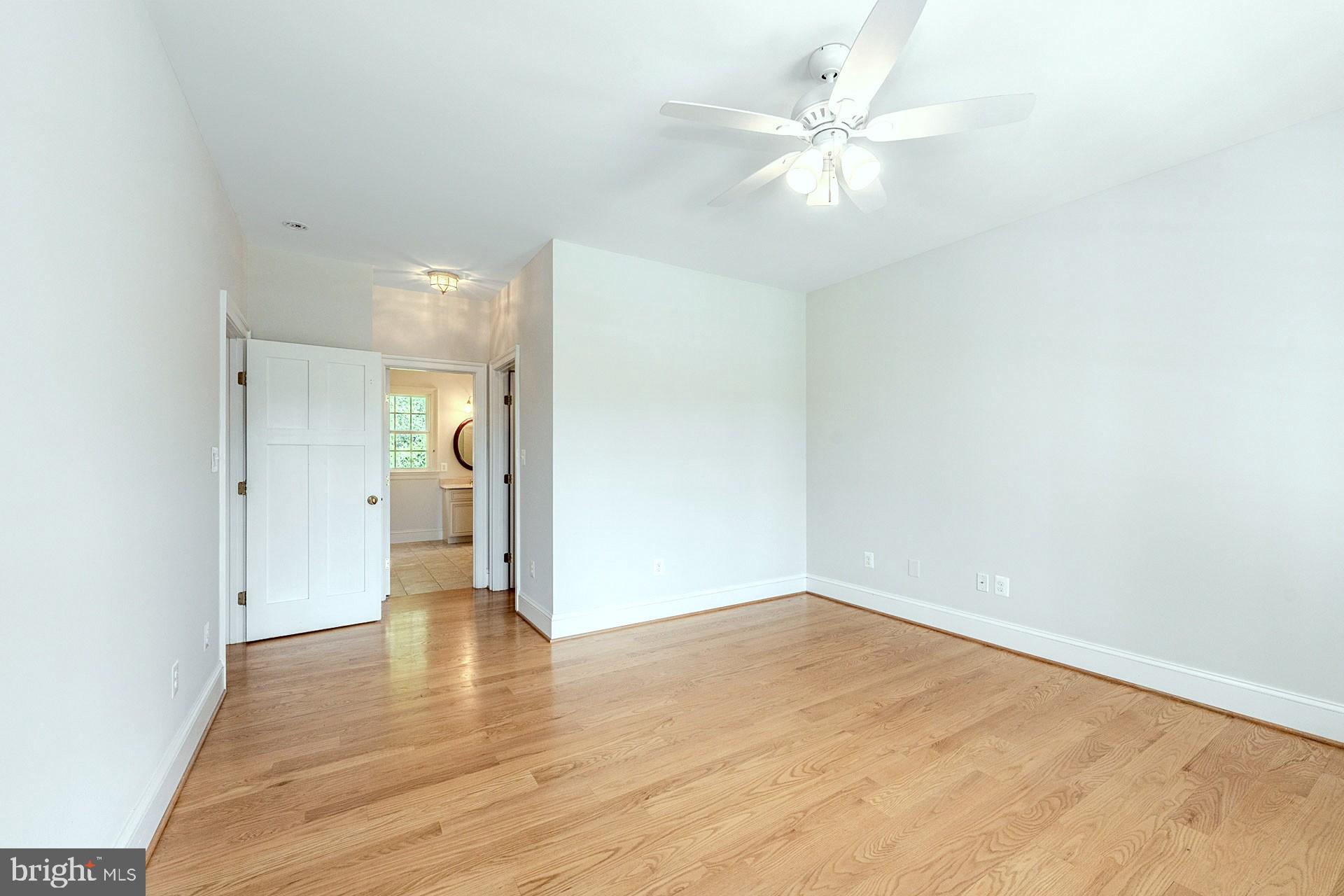 11208 West Montpelier Road Great Falls, VA 22066 - Photo 32 of 77 an empty room with wooden floor and a ceiling fan