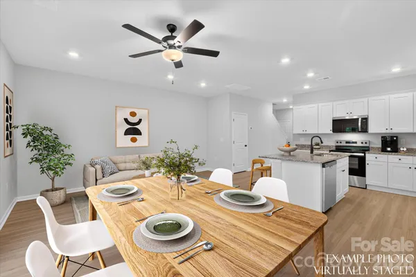 a kitchen with a dining table and chairs