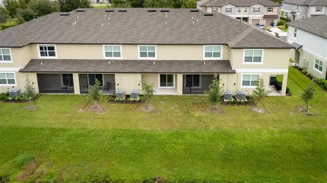 a aerial view of a house yard with swimming pool and porch