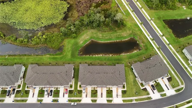 an aerial view of residential houses with outdoor space and street view