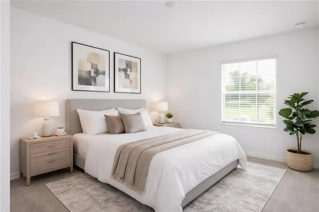 a bedroom with a large bed and a window