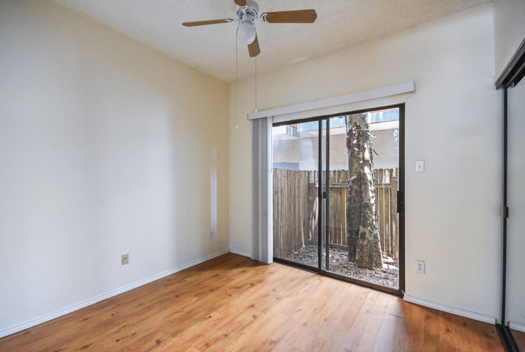 2815 Rio Grande Street, Unit 104 Austin, TX 78705 - Photo 18 of 22 wooden floor in an empty room with a window
