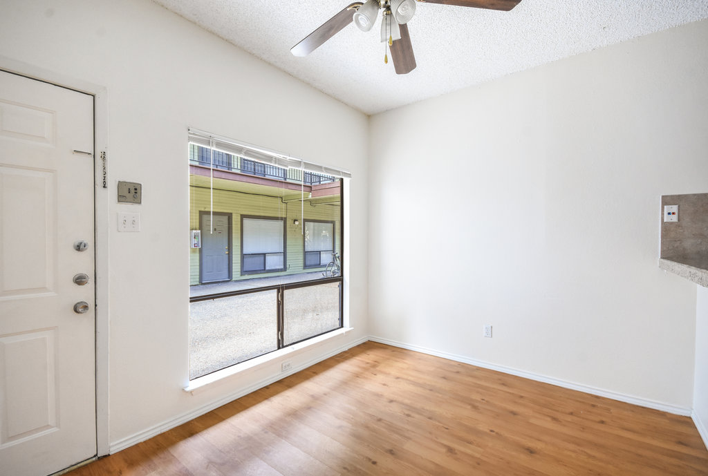 2815 Rio Grande Street, Unit 104 Austin, TX 78705 - Photo 9 of 22 a view of empty room with wooden floor and fan