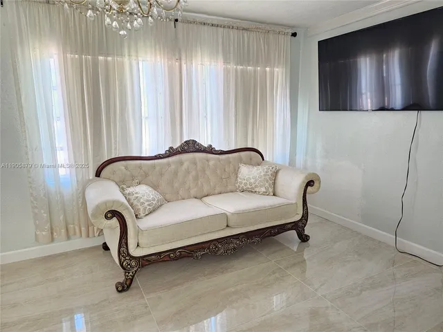 a living room with furniture and a window