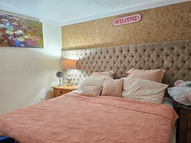 a bedroom with a bed and wall painting