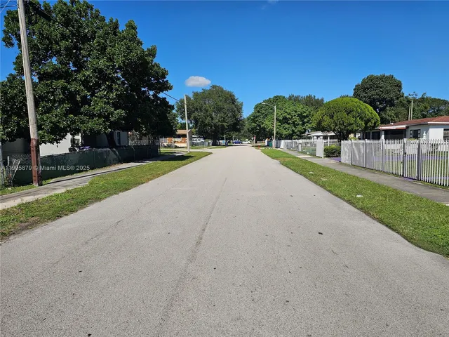 a view of a park with large trees