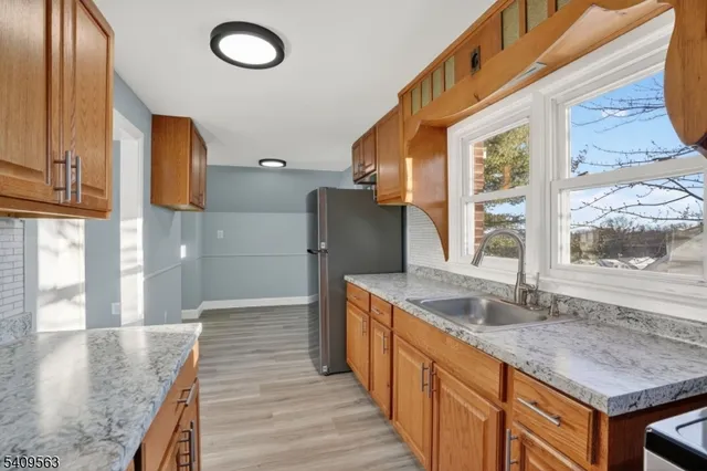 a kitchen with stainless steel appliances granite countertop a sink and a stove