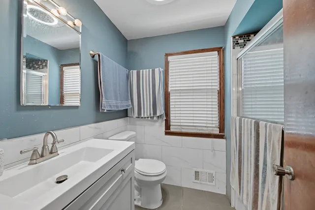 a bathroom with a sink toilet and mirror
