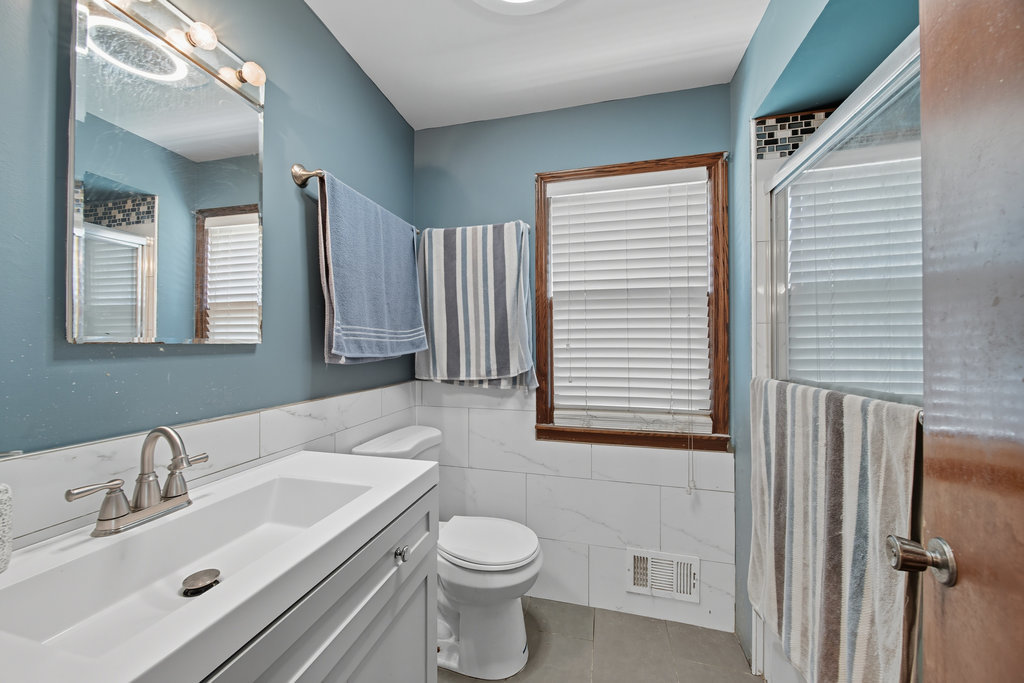 2616 Ridge Road Lansing, IL 60438 - Photo 11 of 25 a bathroom with a sink toilet and mirror