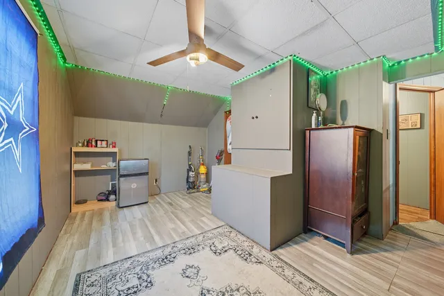 a kitchen with stainless steel appliances a refrigerator and a wooden floor