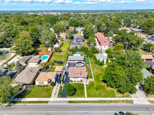 an aerial view of residential houses with outdoor space and street view