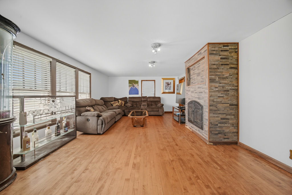 2616 Ridge Road Lansing, IL 60438 - Photo 6 of 25 a living room with furniture a large window and wooden floor
