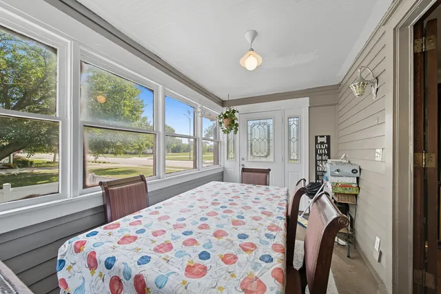 a bedroom with a bed and a large window with the outer view