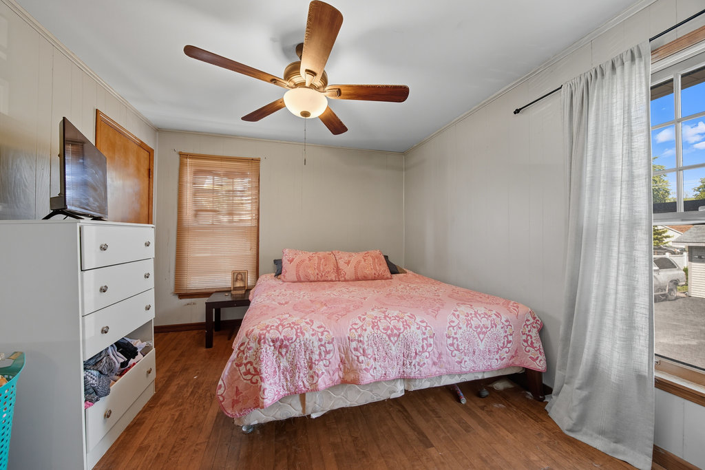 2616 Ridge Road Lansing, IL 60438 - Photo 10 of 25 a bedroom with a bed closet and flat tv screen