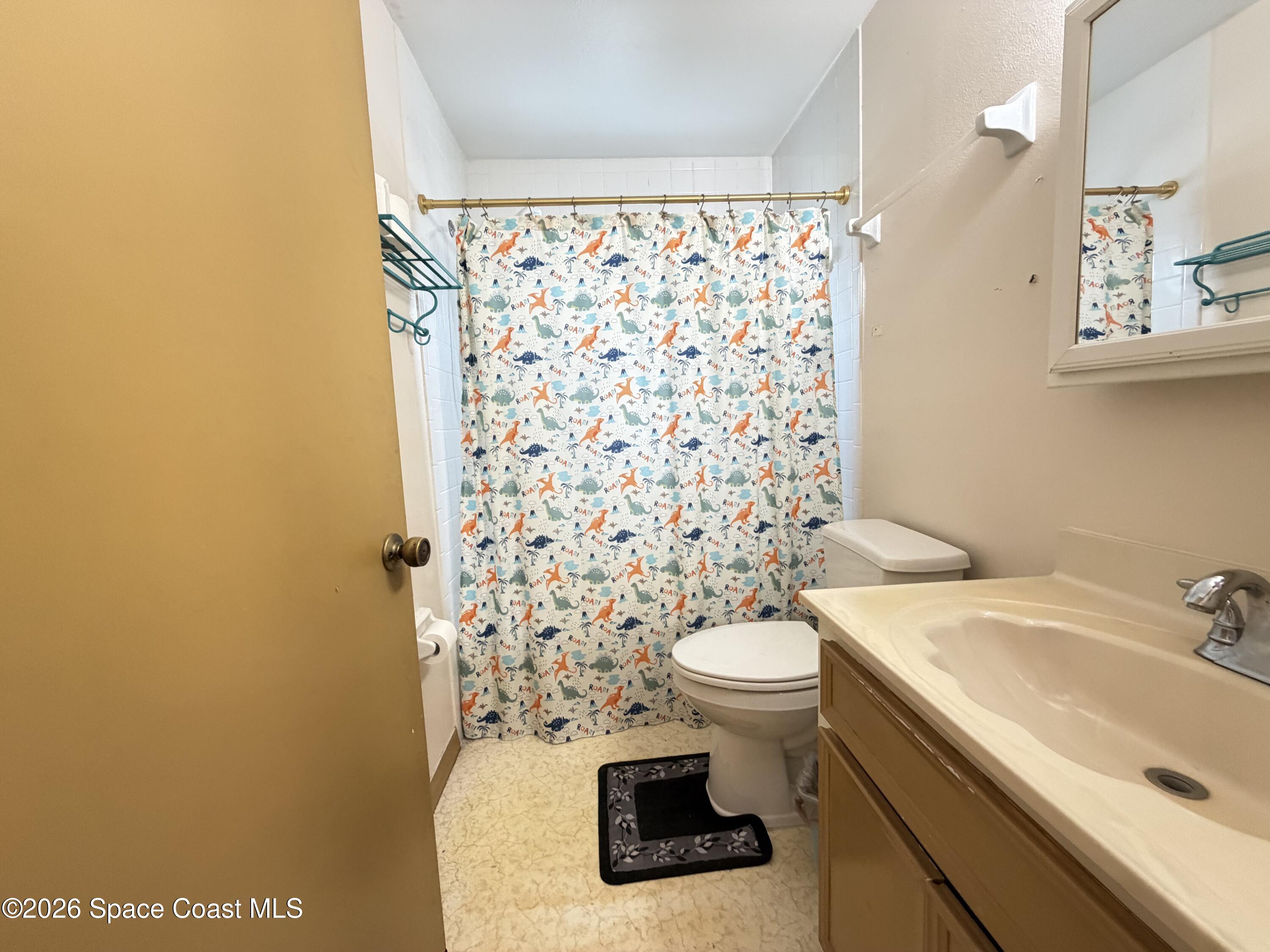1578 West Powder Horn Road Titusville, FL 32796 - Photo 14 of 22 a bathroom with a sink and a toilet
