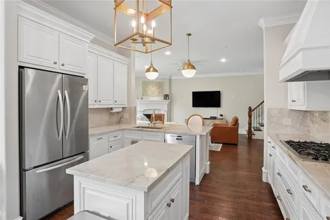 a kitchen with stainless steel appliances a refrigerator stove and microwave