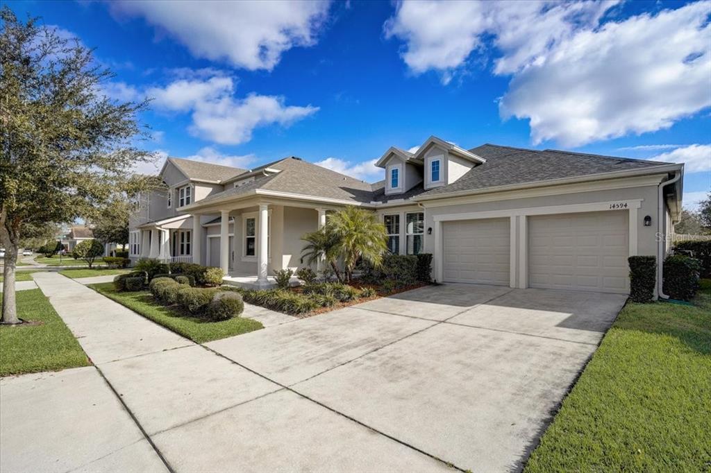 14594 Magnolia Ridge Loop Winter Garden, FL 34787 - Photo 1 of 1 a front view of a house with a yard and potted plants