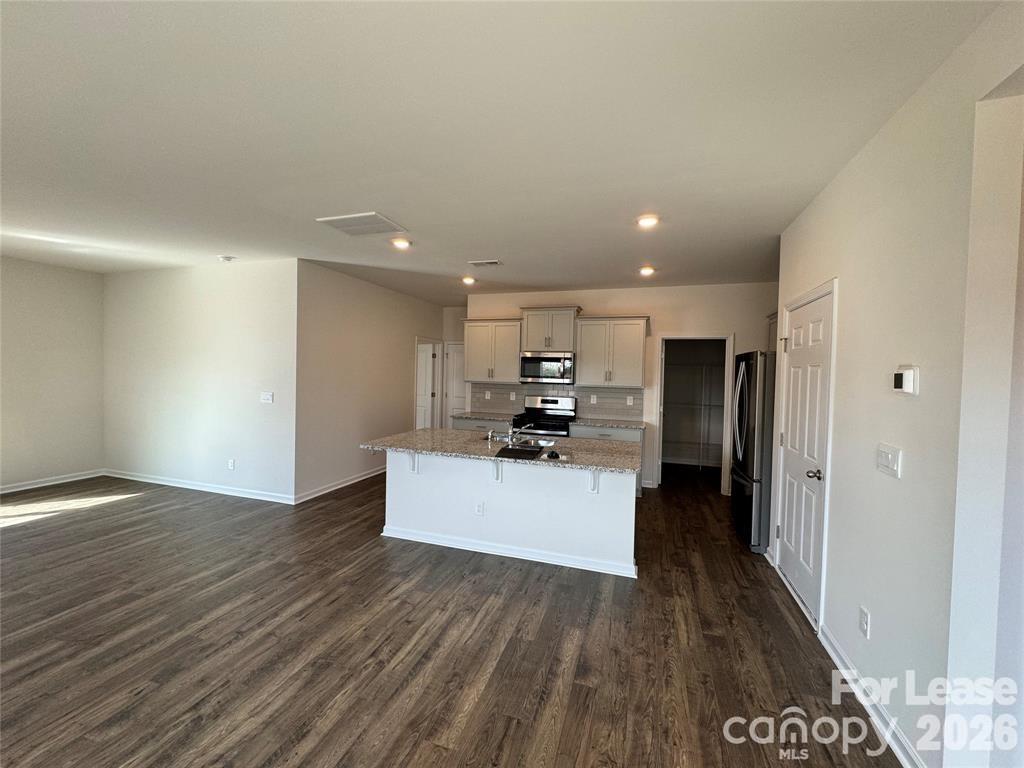 122 Old Home Road Statesville, NC 28677 - Photo 4 of 25 a living room with stainless steel appliances kitchen island hardwood floor sink and stove
