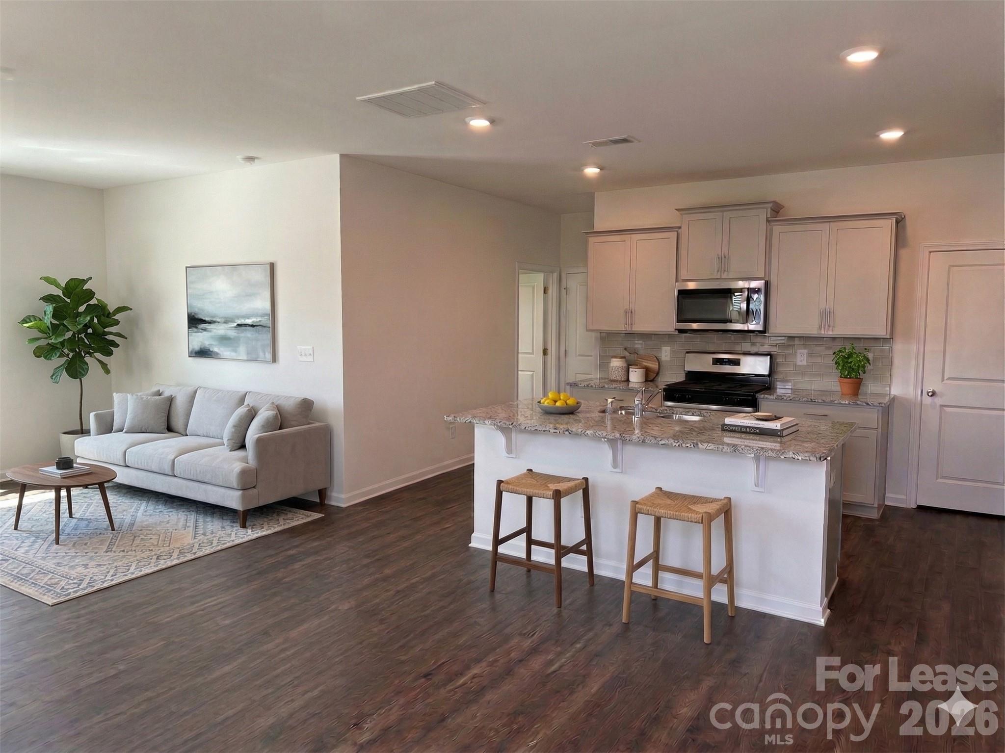 122 Old Home Road Statesville, NC 28677 - Photo 5 of 25 a kitchen with microwave a refrigerator and chairs