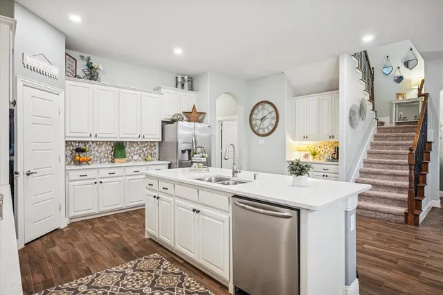 a kitchen with a sink and cabinets