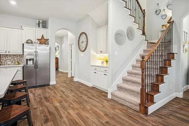 a view of a hallway with wooden floor and entryway