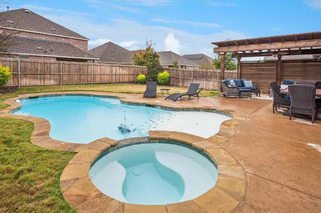 a view of a swimming pool with outdoor seating