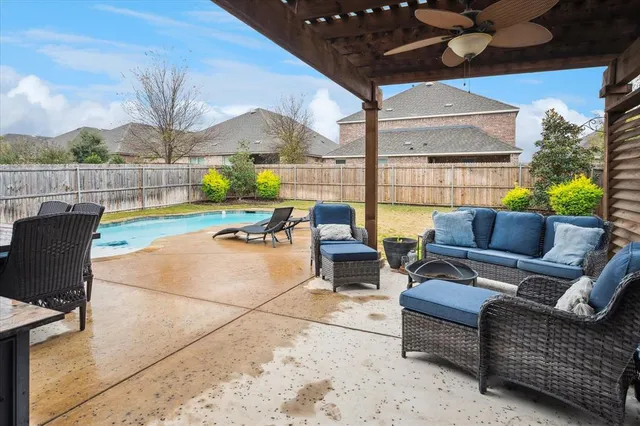 a view of a patio with couches potted plants and a table