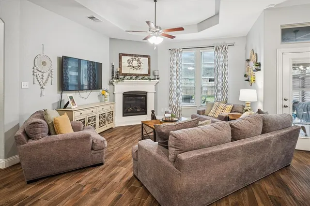 a living room with furniture a flat screen tv and a fireplace