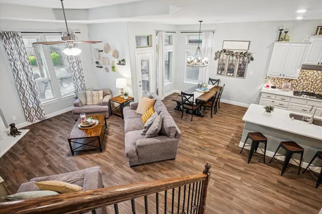 a living room with furniture and wooden floor