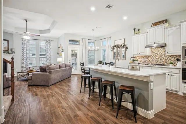 a living room with kitchen island furniture and a wooden floor