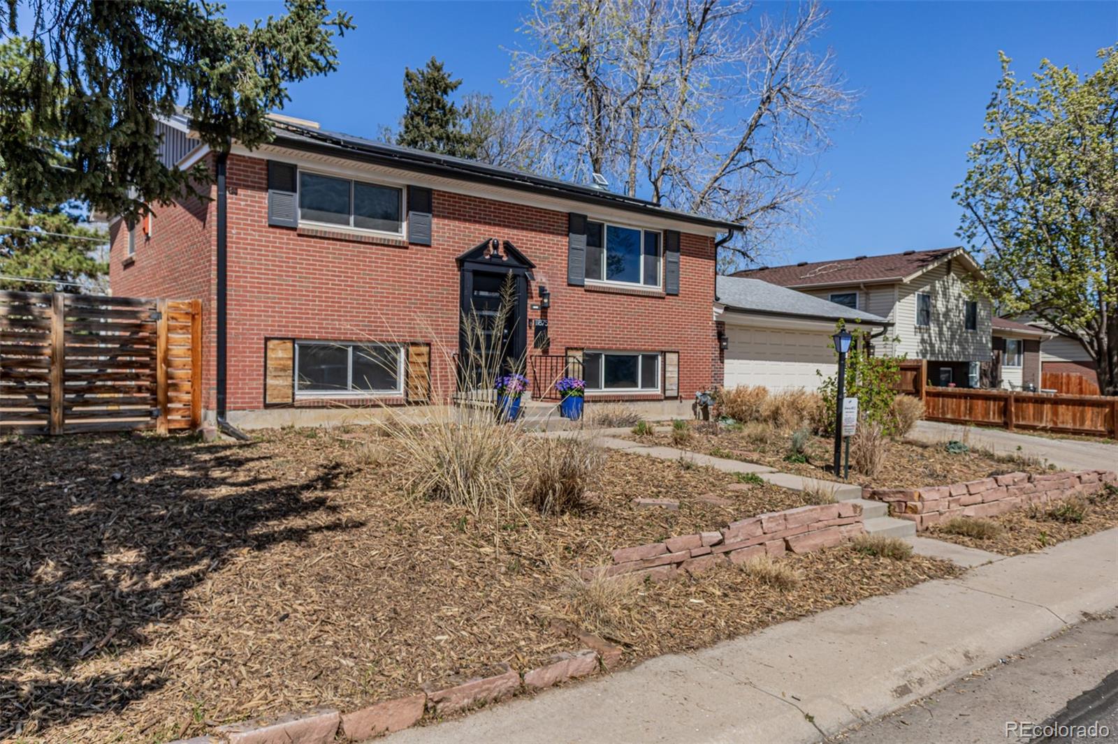 a front view of a house with two yard