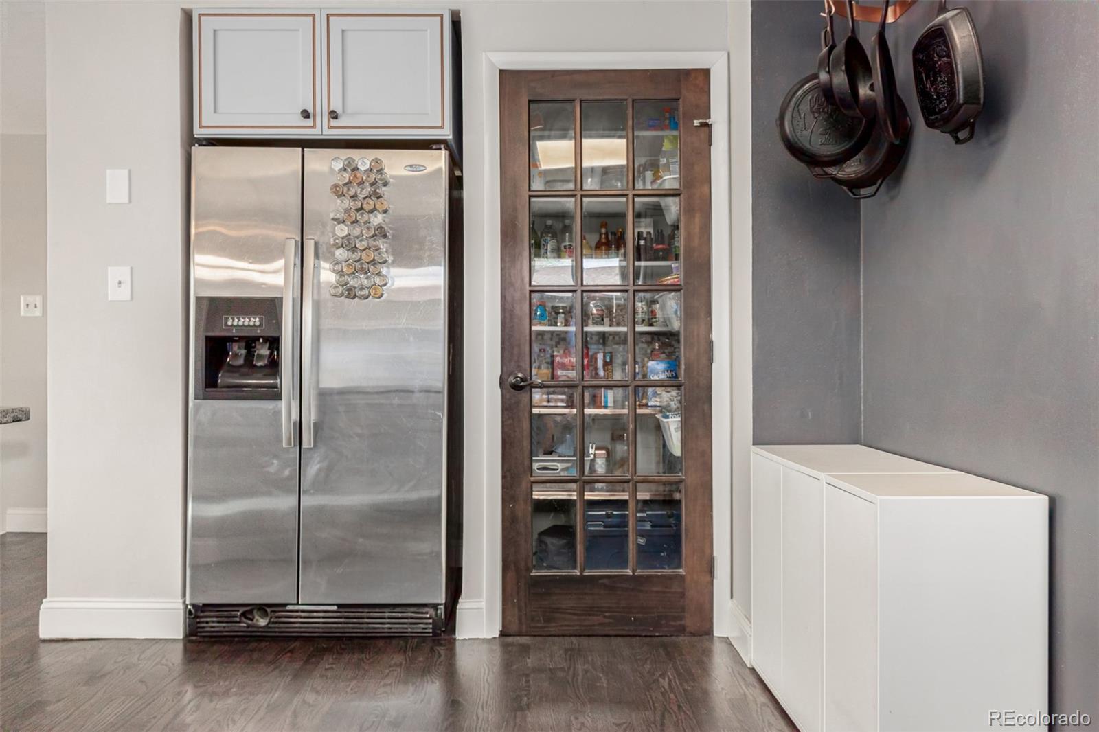 11875 Spring Drive Northglenn, CO 80233 - Photo 11 of 29 a kitchen with a refrigerator and cabinets