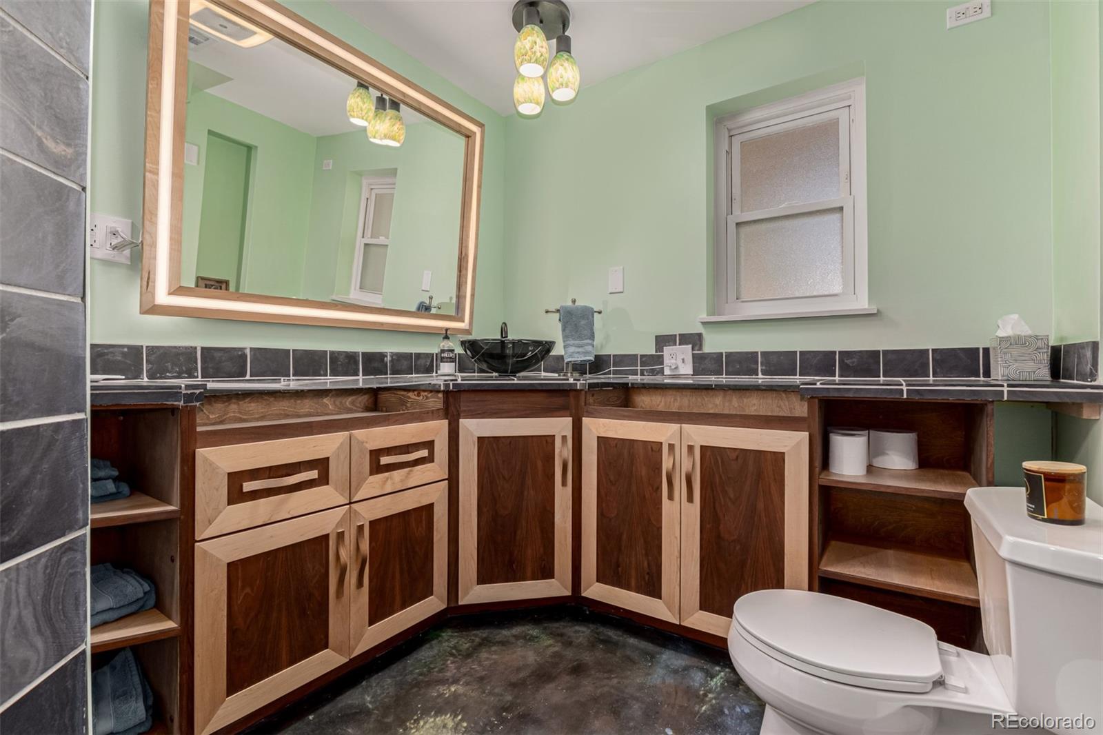11875 Spring Drive Northglenn, CO 80233 - Photo 19 of 29 a bathroom with a sink a toilet and a mirror