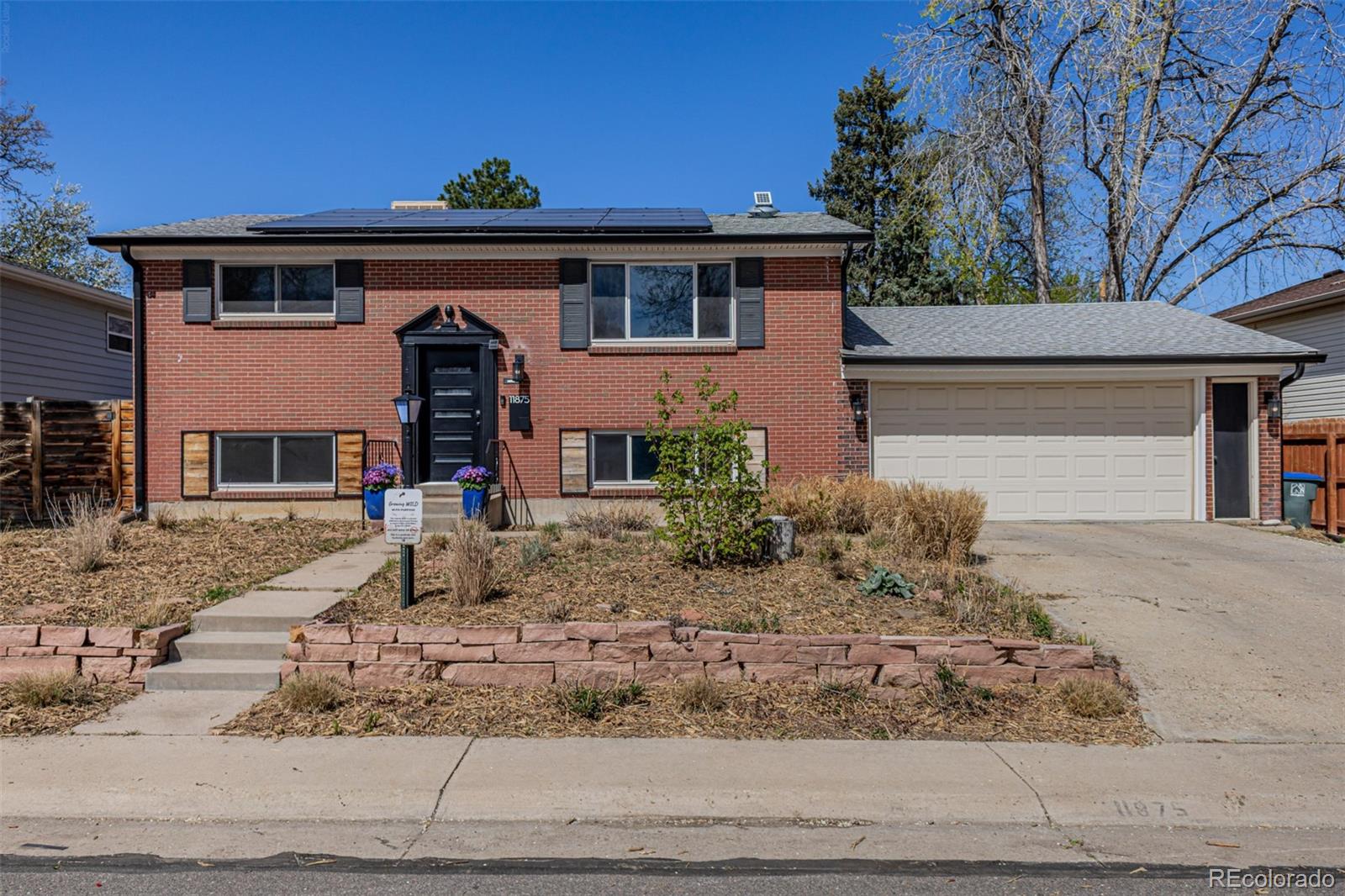 11875 Spring Drive Northglenn, CO 80233 - Photo 2 of 29 a front view of a house with garden