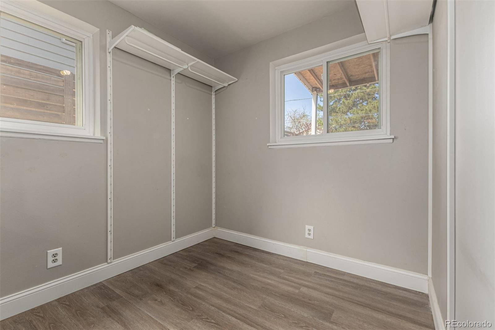 11875 Spring Drive Northglenn, CO 80233 - Photo 21 of 29 a view of an empty room with wooden floor and a window