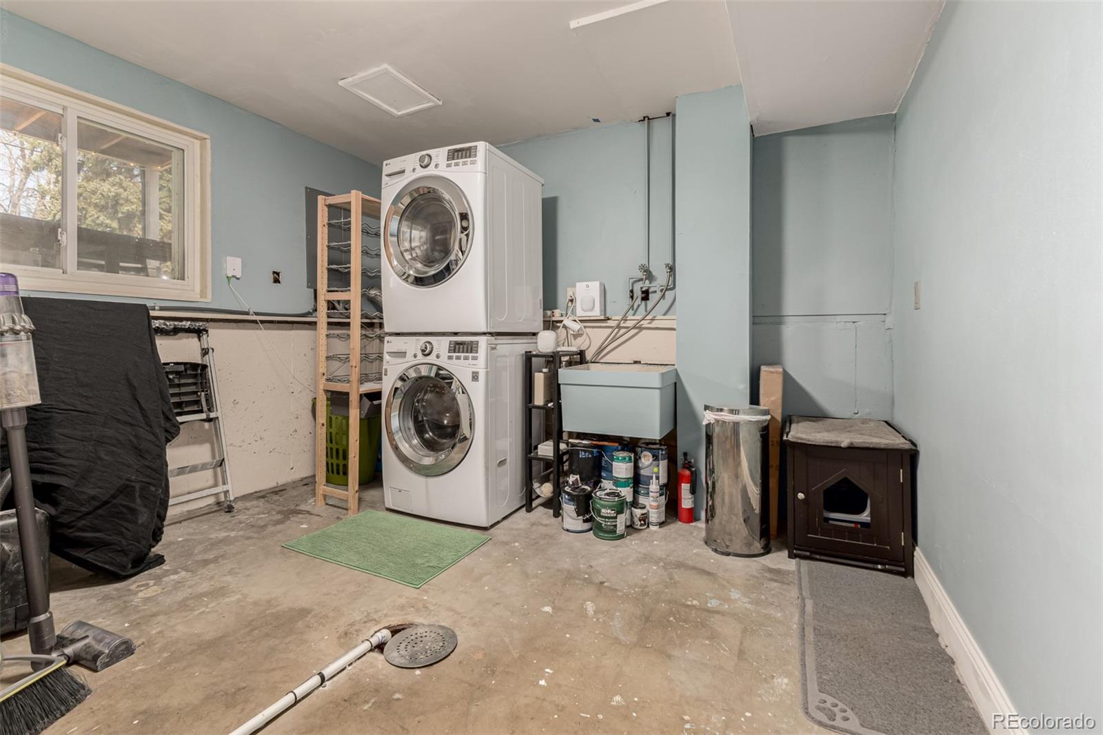 11875 Spring Drive Northglenn, CO 80233 - Photo 25 of 29 a utility room with dryer washer and a view of living room