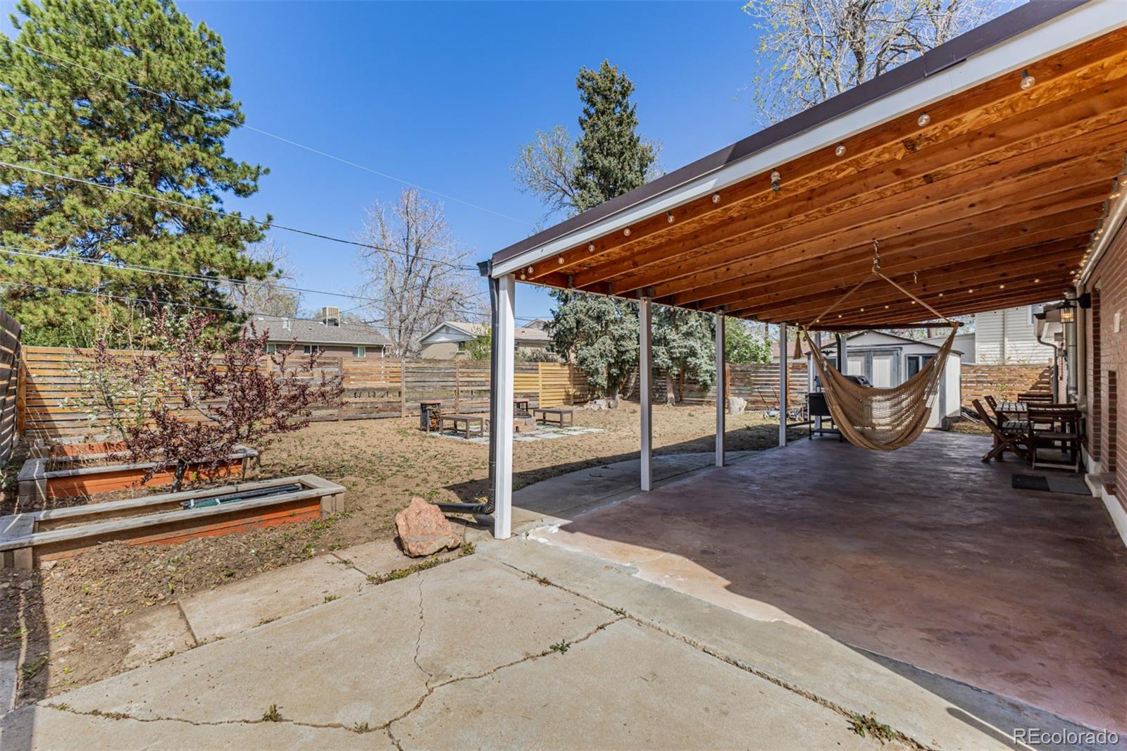 11875 Spring Drive Northglenn, CO 80233 - Photo 27 of 29 a view of a patio with table and chairs and potted plants