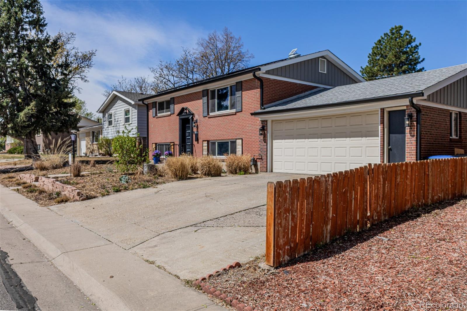 11875 Spring Drive Northglenn, CO 80233 - Photo 3 of 29 a front view of a house with a yard