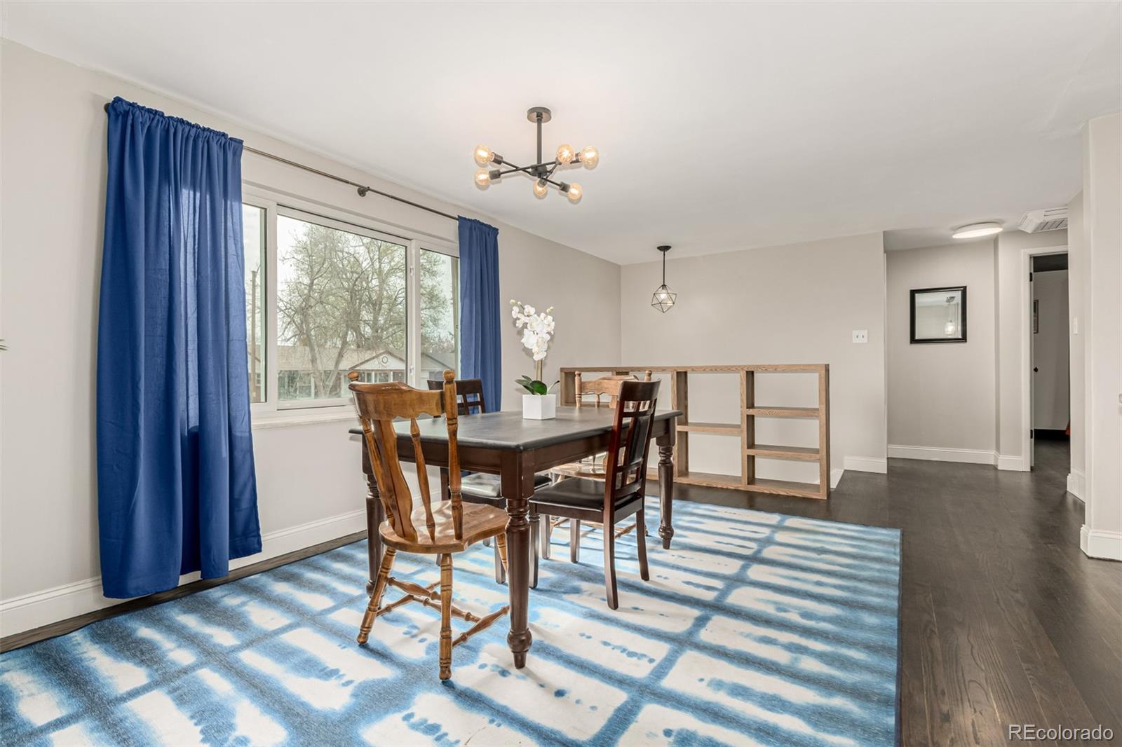 11875 Spring Drive Northglenn, CO 80233 - Photo 5 of 29 a view of a dining room with furniture window and wooden floor