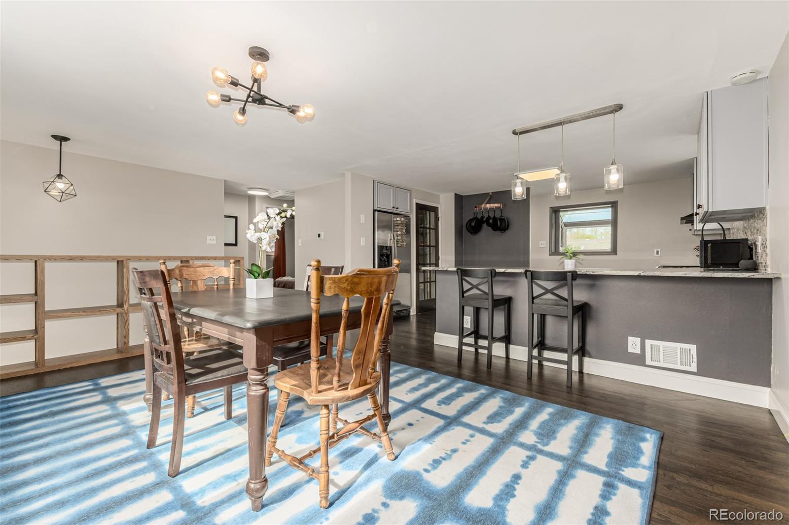 11875 Spring Drive Northglenn, CO 80233 - Photo 6 of 29 a view of a dining room with furniture and wooden floor