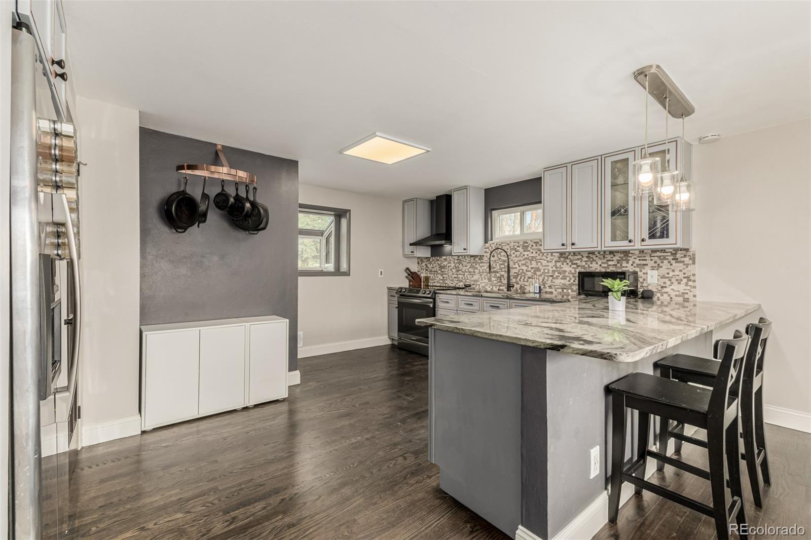 11875 Spring Drive Northglenn, CO 80233 - Photo 7 of 29 a kitchen with stainless steel appliances granite countertop a stove and white cabinets