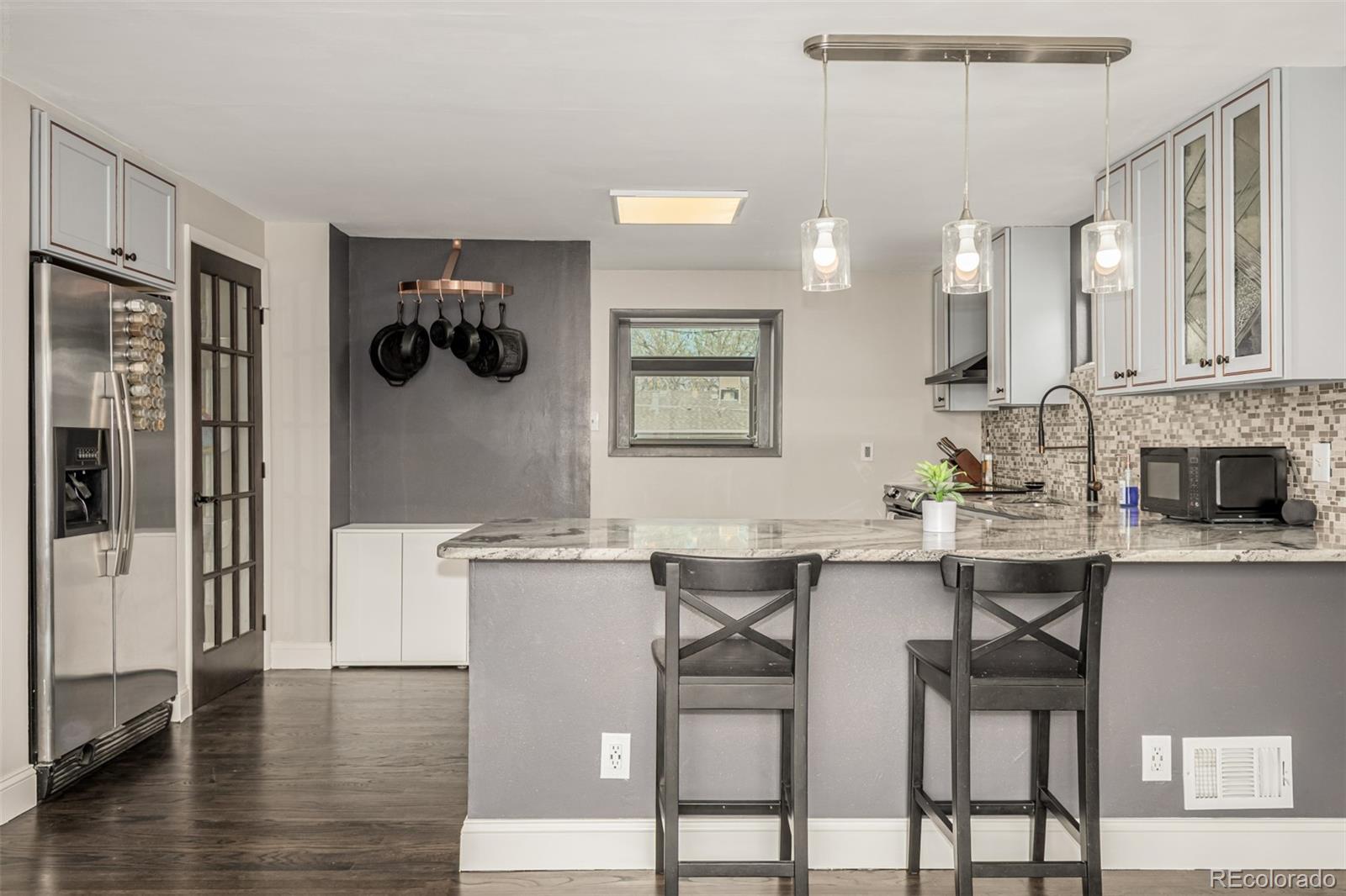11875 Spring Drive Northglenn, CO 80233 - Photo 8 of 29 a kitchen with a table and chairs in it
