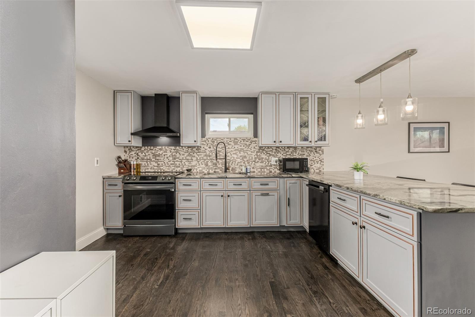 11875 Spring Drive Northglenn, CO 80233 - Photo 9 of 29 a kitchen with a stove a sink and a refrigerator