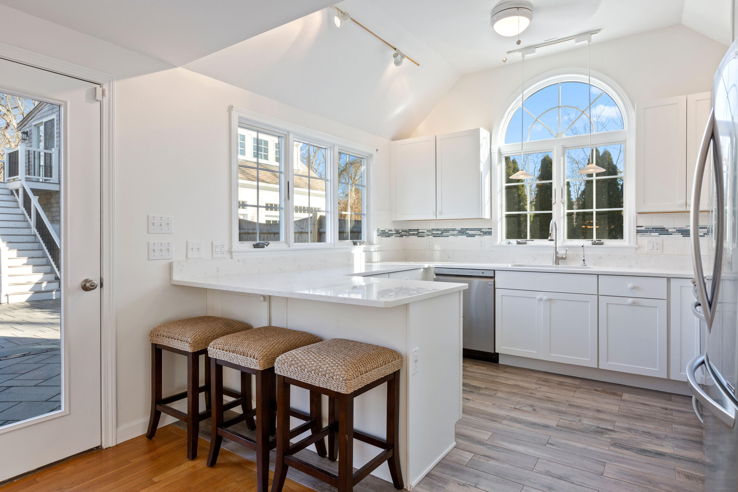 220 Hay Road Eastham, MA 02642 - Photo 13 of 54 a kitchen with a table chairs sink and cabinets