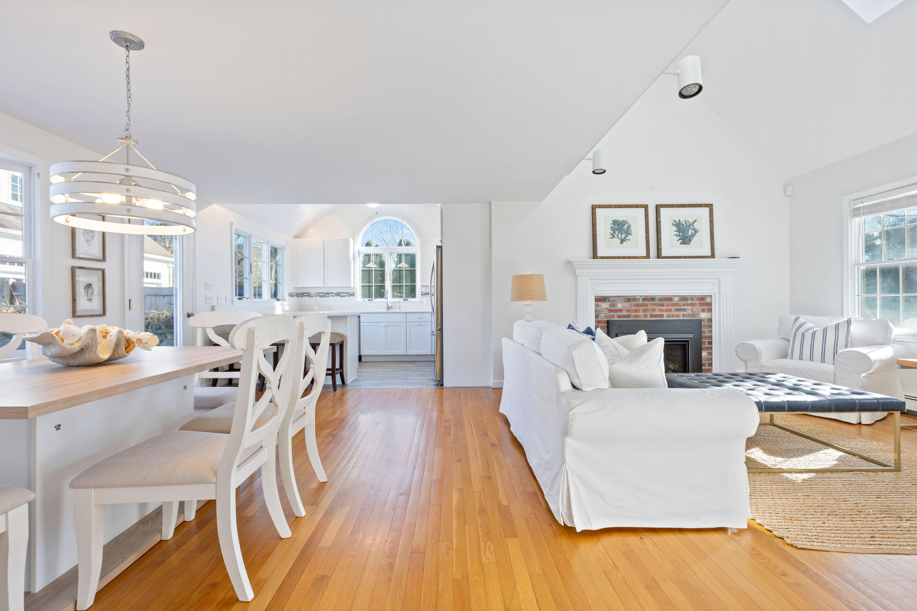 220 Hay Road Eastham, MA 02642 - Photo 16 of 54 a living room with furniture a fireplace and a chandelier