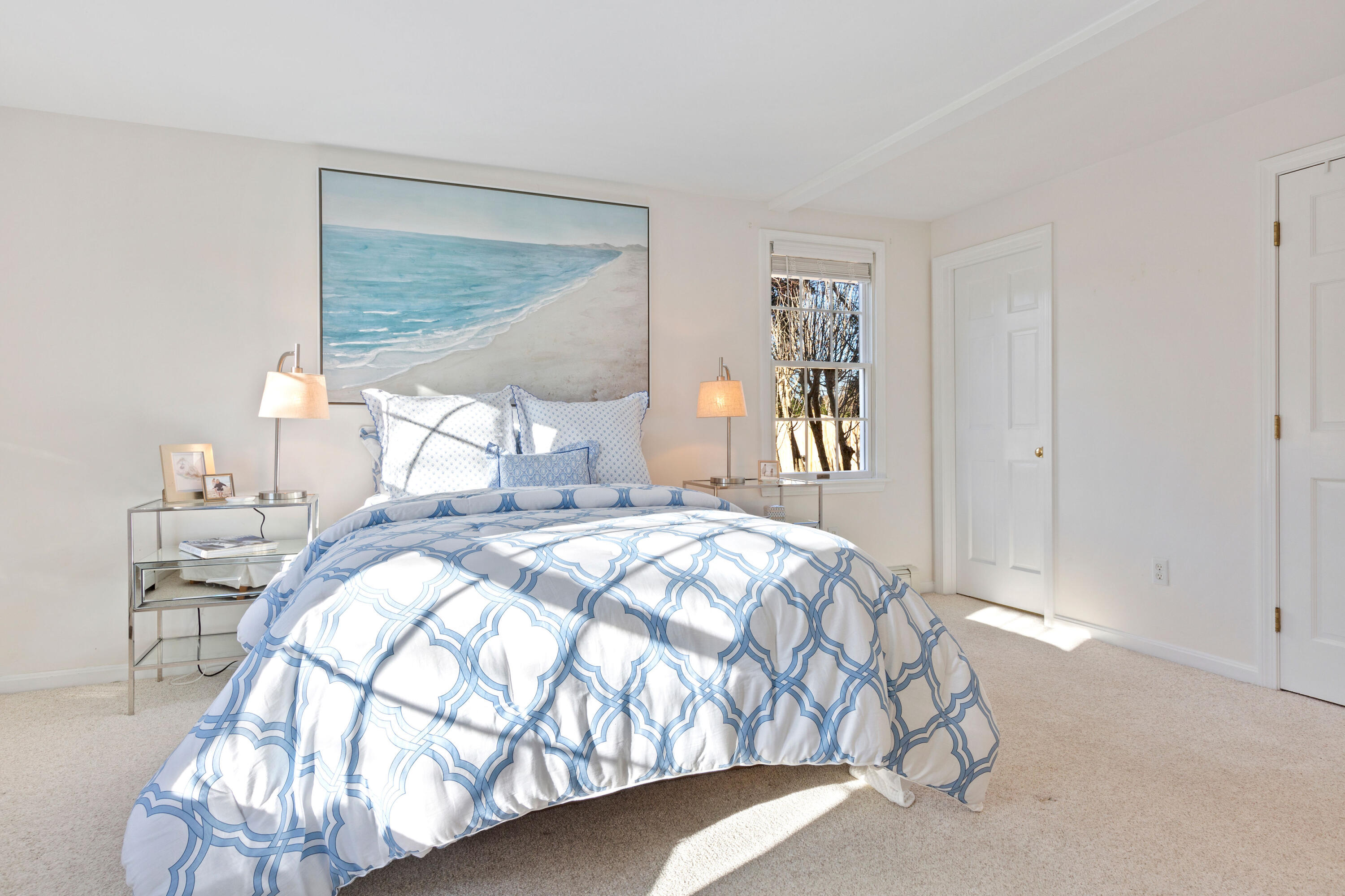 220 Hay Road Eastham, MA 02642 - Photo 23 of 54 a bedroom with a large bed and a chandelier