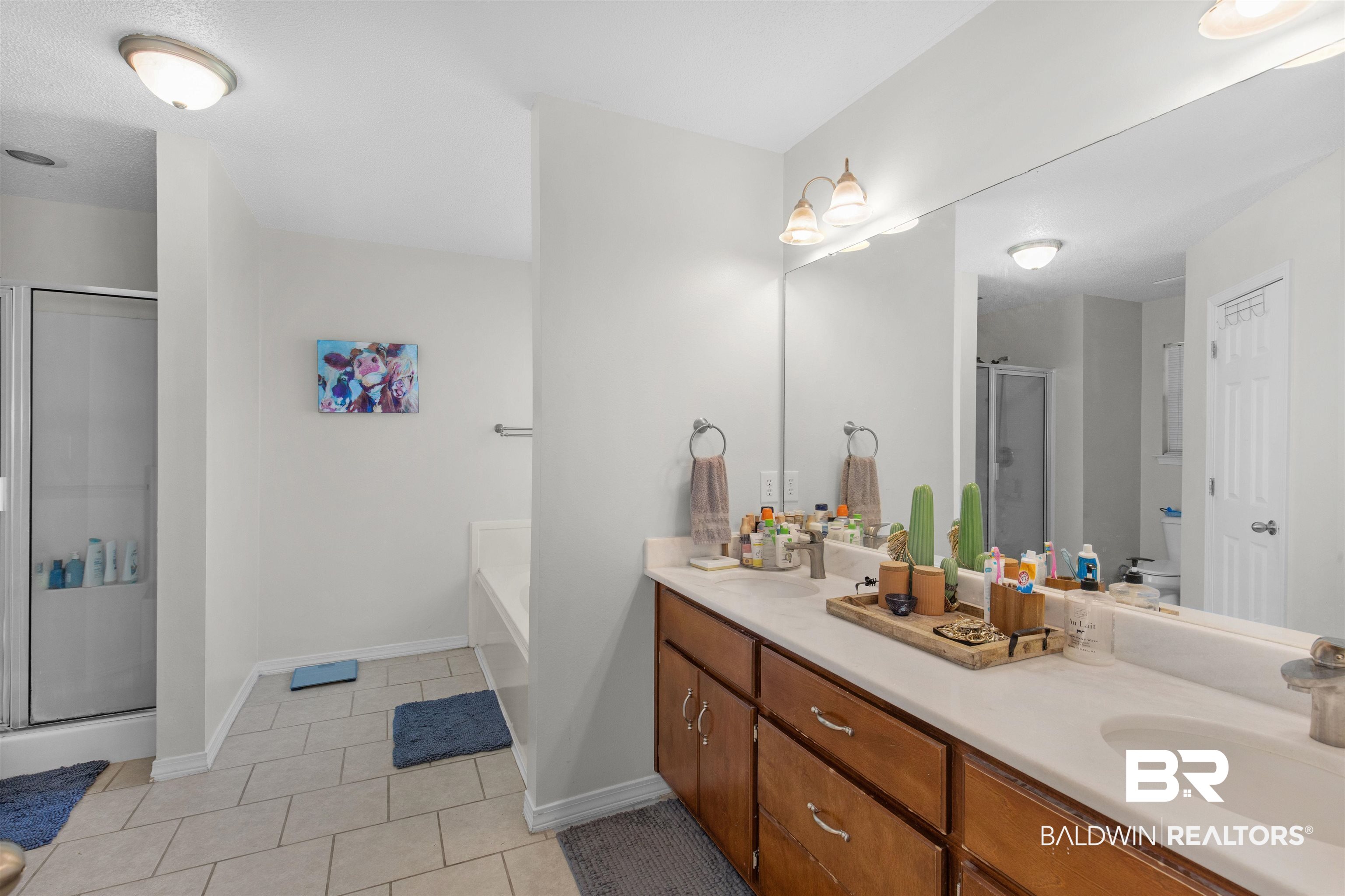 4950 Clealand Court Mobile, AL 36695 - Photo 11 of 20 Full bathroom featuring a garden tub, tile patterned flooring, a sink, a shower stall, and double vanity