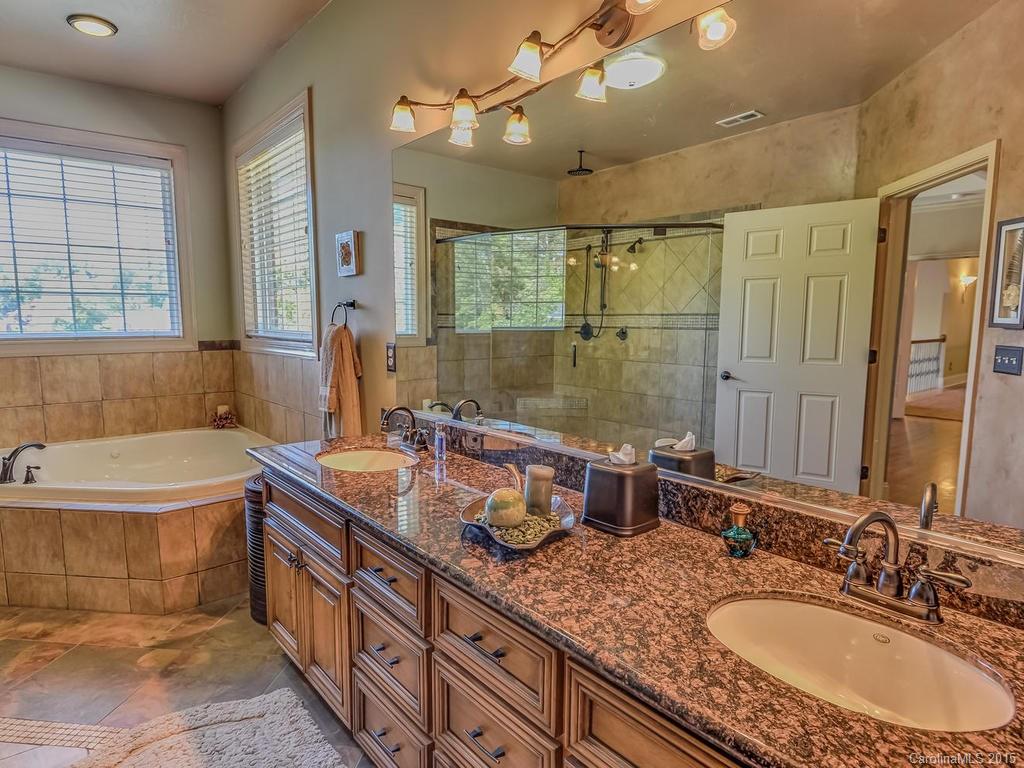 275 Whippoorwill Road Mooresville, NC 28117 - Photo 15 of 24 a bathroom with a granite countertop double vanity sink a mirror and a bathtub